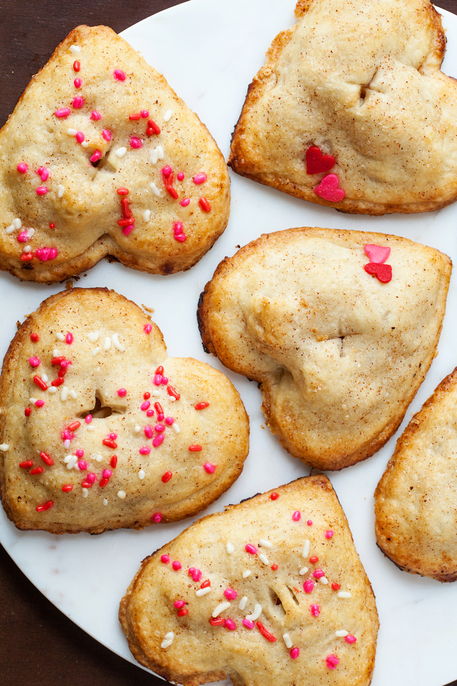 These heart apple hand pies are completely irresistible with their utterly flaky crust and scrumptious cinnamon and apple filling.