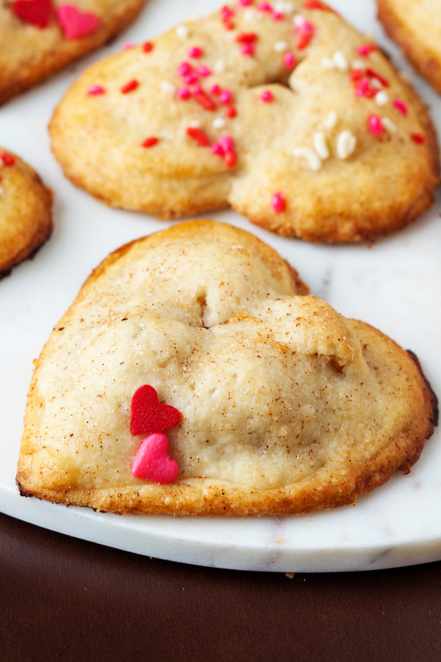 These heart apple hand pies are completely irresistible with their utterly flaky crust and scrumptious cinnamon and apple filling.