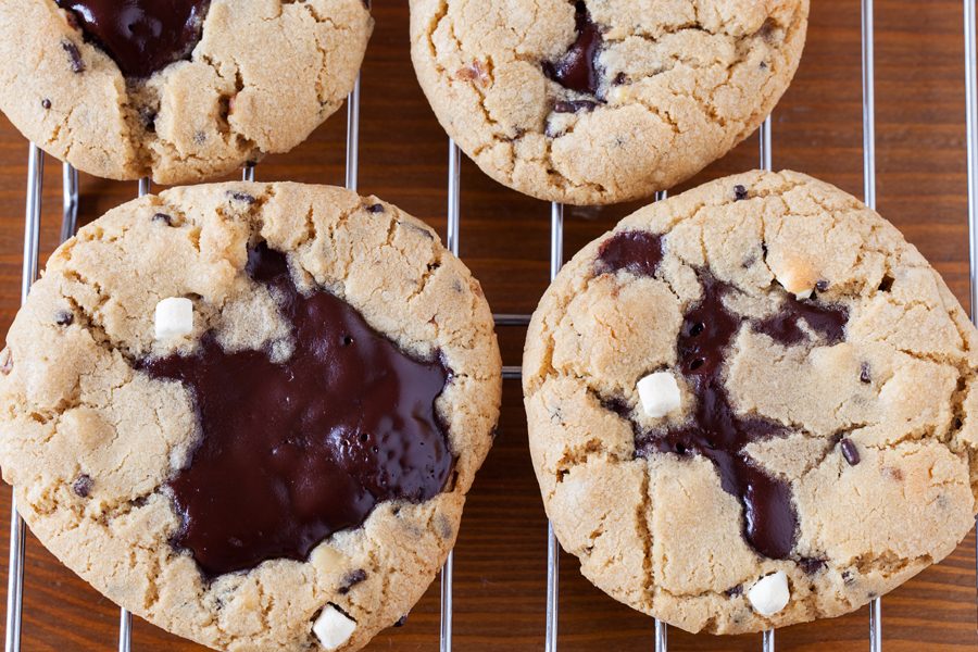 Rocky road reincarnated in cookie form. Full of marshmallows and walnuts, these rocky road cookies are soft, chewy, and gushing with rich ganache.