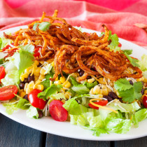 Crispy spiralized potatoes tossed in a taco seasoned sauce makes for a no-dressing-needed salad.