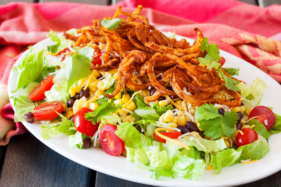 Crispy spiralized potato tossed in a taco seasoned sauce makes for a no-dressing-needed salad.