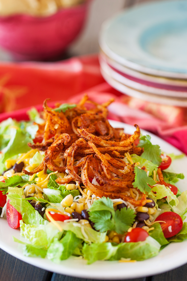 Crispy spiralized potato tossed in a taco seasoned sauce makes for a no-dressing-needed salad.