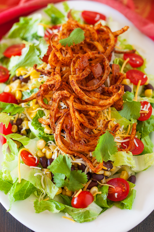 Crispy spiralized potato tossed in a taco seasoned sauce makes for a no-dressing-needed salad.