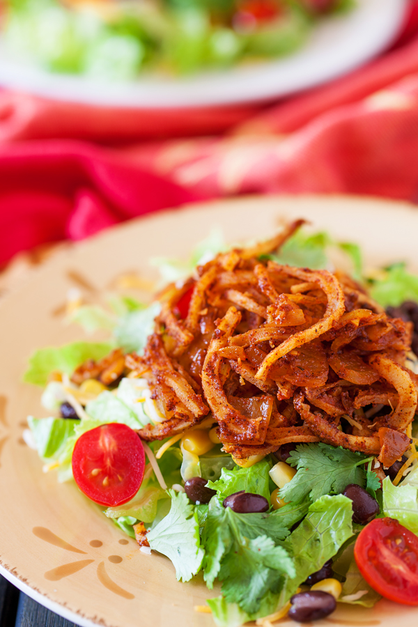 Crispy spiralized potato tossed in a taco seasoned sauce makes for a no-dressing-needed salad.