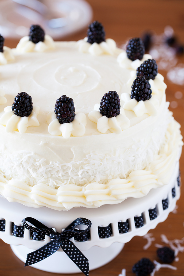 A cake for all occasions, this Blackberry Coconut Cake has a dense and moist crumb of blackberries and coconut, is filled with rich coconut buttercream, and frosted with tangy cream cheese frosting. Perfect for berry and coconut lovers everywhere. 