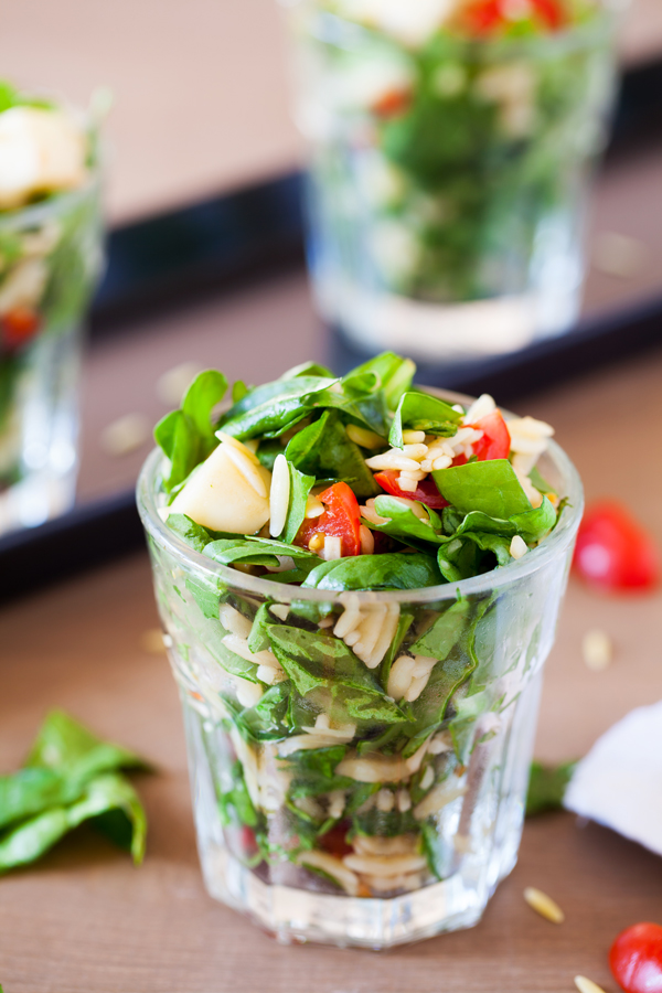 Classic caprese ingredients (basil, mozzarella, tomatoes, and balsamic vinaigrette) modernized into a salad with spinach and orzo pasta.