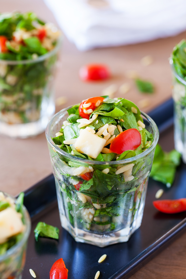 Classic caprese ingredients (basil, mozzarella, tomatoes, and balsamic vinaigrette) modernized into a salad with spinach and orzo pasta.