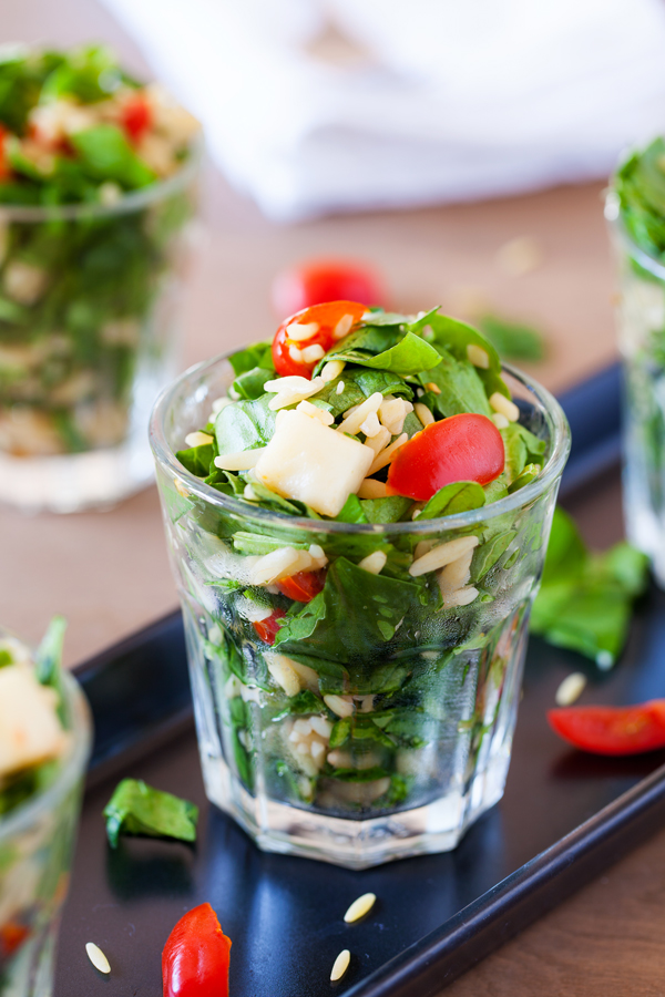 Classic caprese ingredients (basil, mozzarella, tomatoes, and balsamic vinaigrette) modernized into a salad with spinach and orzo pasta.