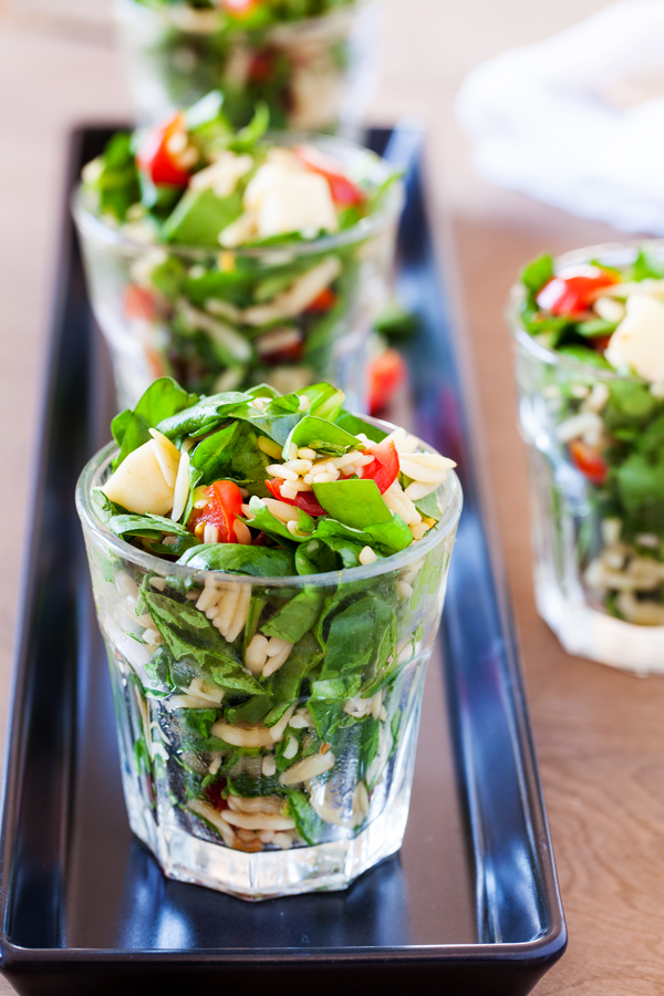 Classic caprese ingredients (basil, mozzarella, tomatoes, and balsamic vinaigrette) modernized into a salad with spinach and orzo pasta.