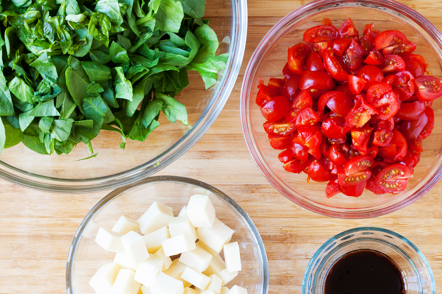 Classic caprese ingredients (basil, mozzarella, tomatoes, and balsamic vinaigrette) modernized into a salad with spinach and orzo pasta.