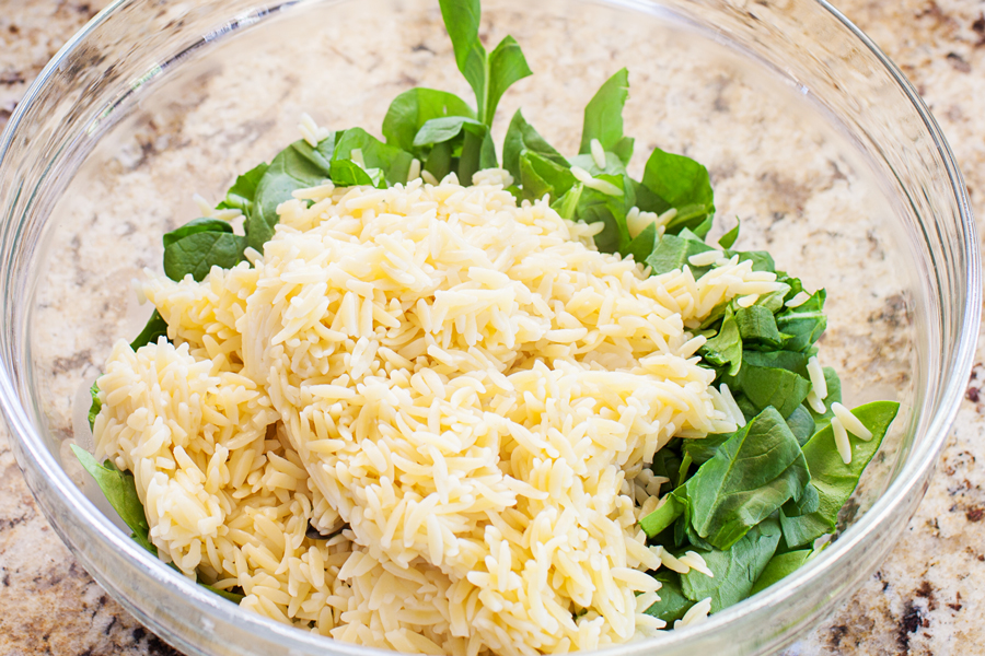 Classic caprese ingredients (basil, mozzarella, tomatoes, and balsamic vinaigrette) modernized into a salad with spinach and orzo pasta.