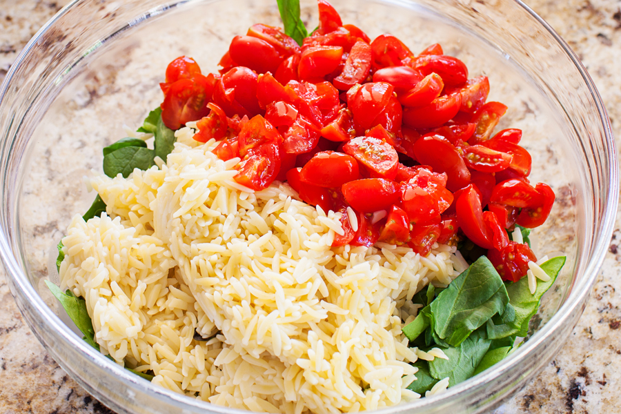 Classic caprese ingredients (basil, mozzarella, tomatoes, and balsamic vinaigrette) modernized into a salad with spinach and orzo pasta.