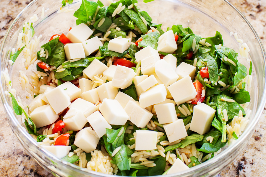 Classic caprese ingredients (basil, mozzarella, tomatoes, and balsamic vinaigrette) modernized into a salad with spinach and orzo pasta.