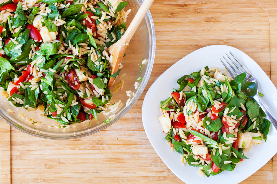 Classic caprese ingredients (basil, mozzarella, tomatoes, and balsamic vinaigrette) modernized into a salad with spinach and orzo pasta.