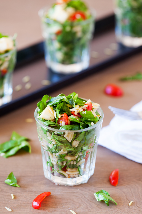 Classic caprese ingredients (basil, mozzarella, tomatoes, and balsamic vinaigrette) modernized into a salad with spinach and orzo pasta.