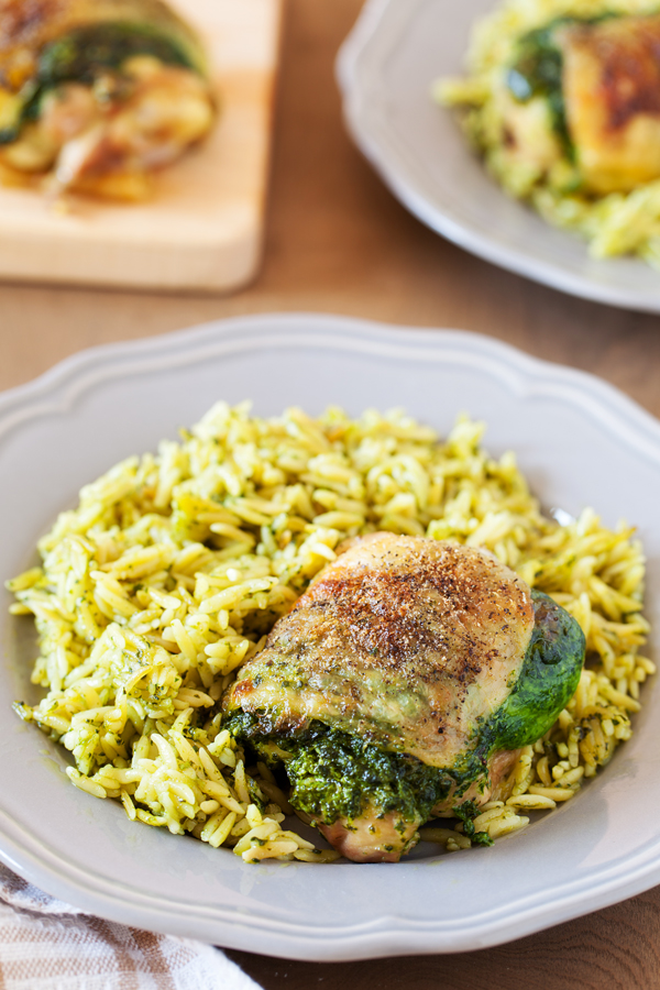 Entrée and side are ready at the same time with this Creamy Spinach Stuffed Chicken with Orzo. Chicken thighs are stuffed with a mixture of spinach and cheese then cooked together with orzo for an easy one-pan dinner.