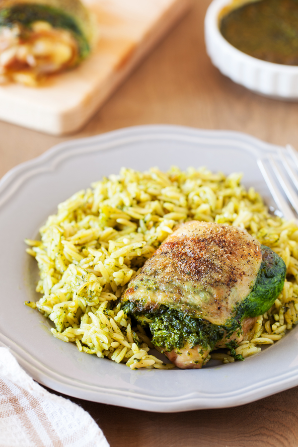 Entrée and side are ready at the same time with this Creamy Spinach Stuffed Chicken with Orzo. Chicken thighs are stuffed with a mixture of spinach and cheese then cooked together with orzo for an easy one-pan dinner.