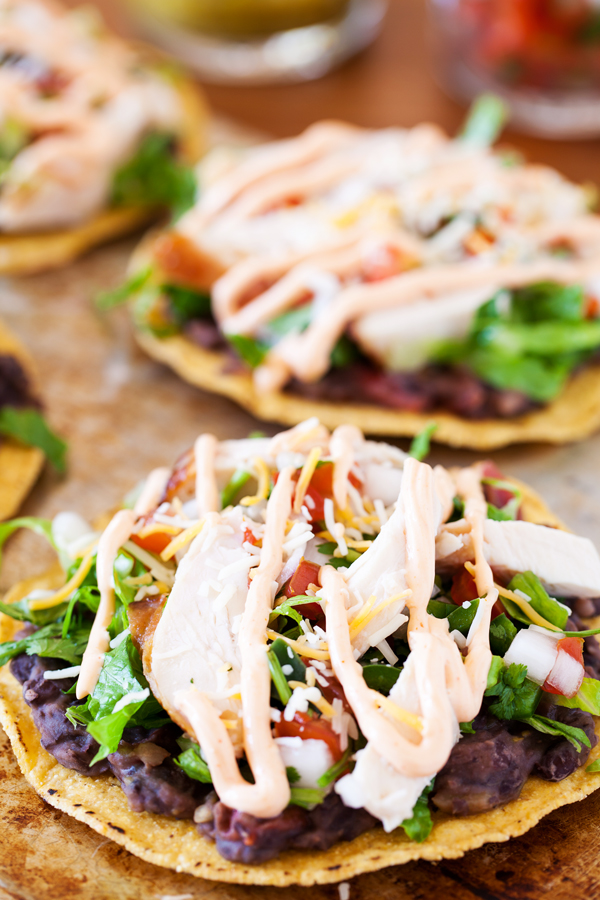 These spicy chicken tostadas are so easy and can be thrown together in minutes for a no-planning-involved Cinco de Mayo celebration or a twist on taco nights.