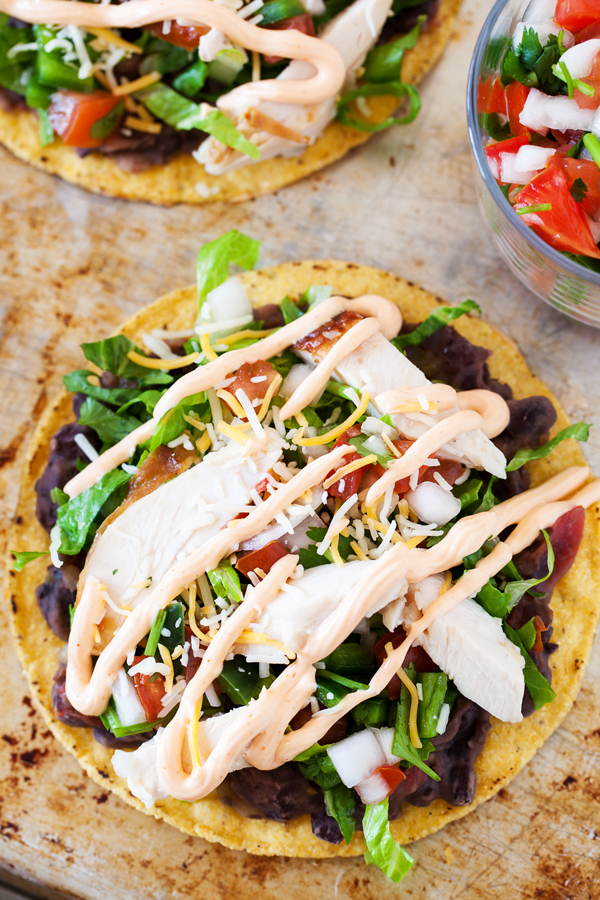 These spicy chicken tostadas are so easy and can be thrown together in minutes for a no-planning-involved Cinco de Mayo celebration or a twist on taco nights.