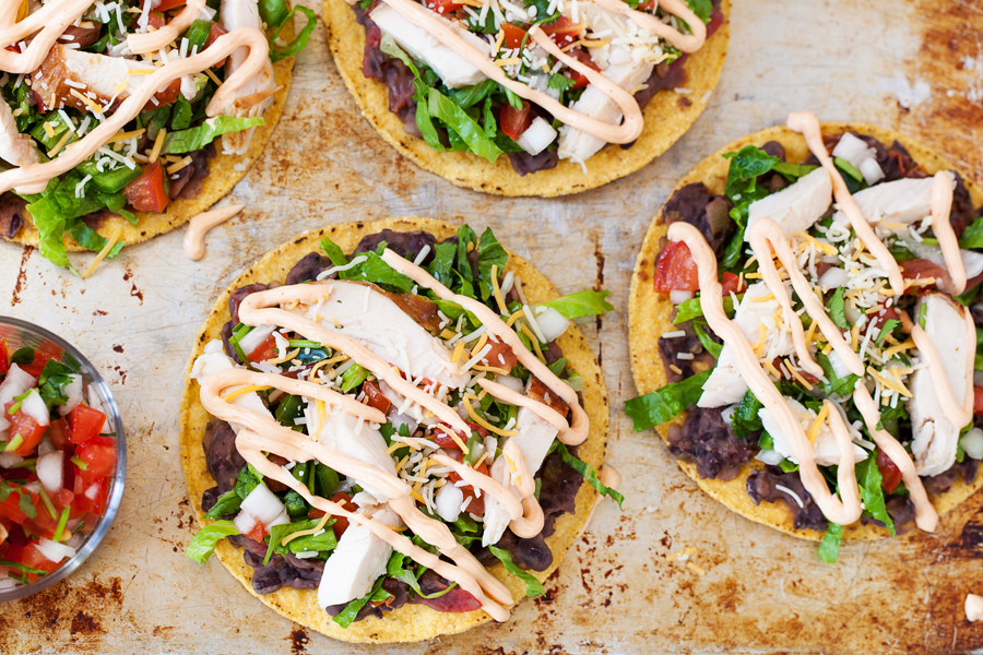 These spicy chicken tostadas are so easy and can be thrown together in minutes for a no-planning-involved Cinco de Mayo celebration or a twist on taco nights.