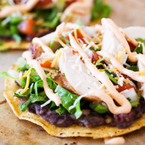 These spicy chicken tostadas are so easy and can be thrown together in minutes for a no-planning-involved Cinco de Mayo celebration or a twist on taco nights.