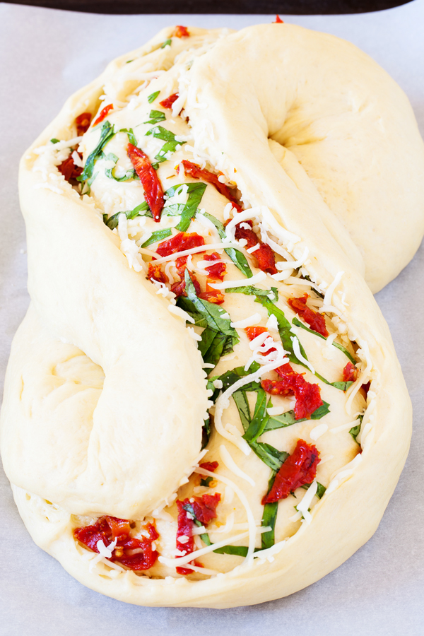 Great for bread baking beginners, this Pane Bianco (Italian for White Bread) is filled with sun-dried tomatoes, garlic, fresh basil, and mozzarella cheese, that will sure to impress.