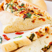 Great for bread baking beginners, this Pane Bianco (Italian for White Bread) is filled with sun-dried tomatoes, garlic, fresh basil, and mozzarella cheese, that will sure to impress.