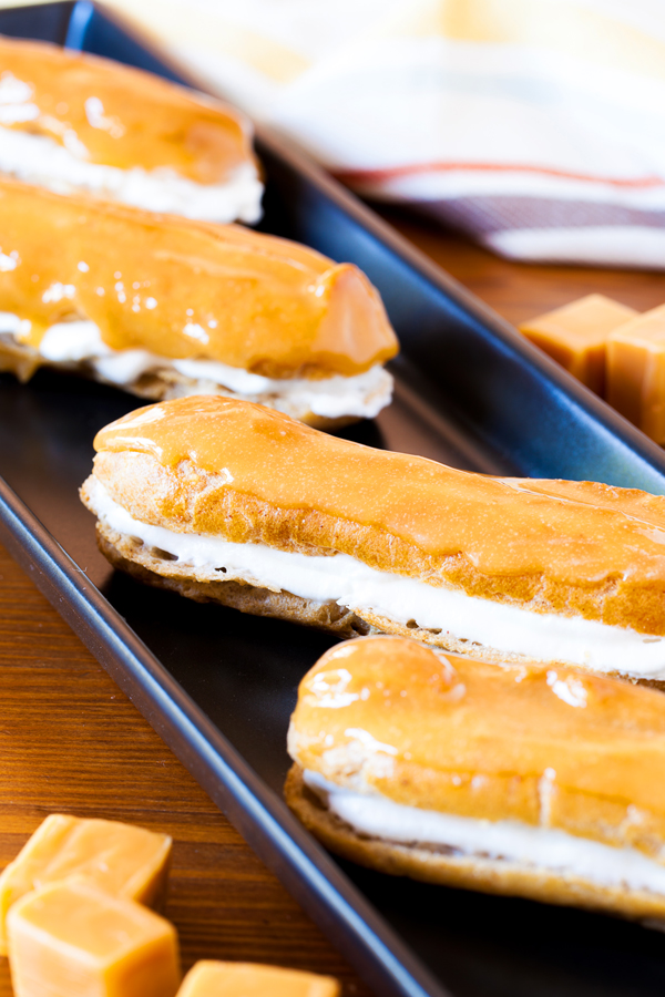 These Pumpkin Pie Spice Éclairs are made from a pumpkin pie spiced pate a choux, are filled with pumpkin pie spice whipped cream, and topped with a delicious caramel glaze that will sure to impress this holiday season.