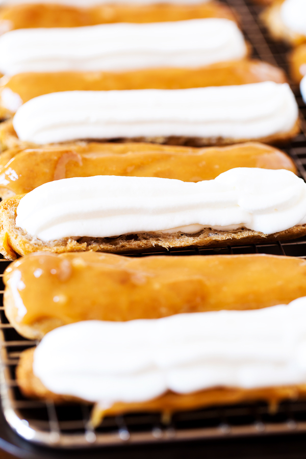 These Pumpkin Pie Spice Éclairs are made from a pumpkin pie spiced pate a choux, are filled with pumpkin pie spice whipped cream, and topped with a delicious caramel glaze that will sure to impress this holiday season.