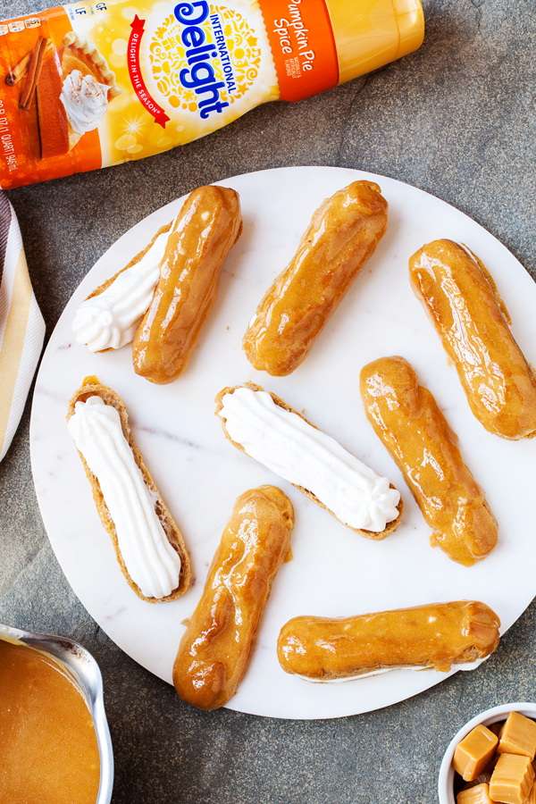 These Pumpkin Pie Spice Éclairs are made from a pumpkin pie spiced pate a choux, are filled with pumpkin pie spice whipped cream, and topped with a delicious caramel glaze that will sure to impress this holiday season.