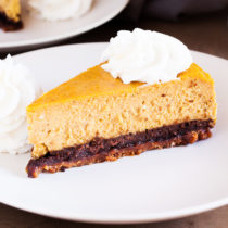 A gingersnap cookie crust, a layer of chocolate cake, and creamy pumpkin cheesecake make this the Ultimate Pumpkin Cheesecake.