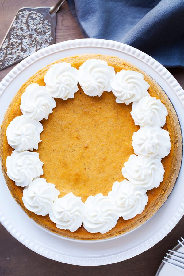 A gingersnap cookie crust, a layer of chocolate cake, and creamy pumpkin cheesecake make this the Ultimate Pumpkin Cheesecake.