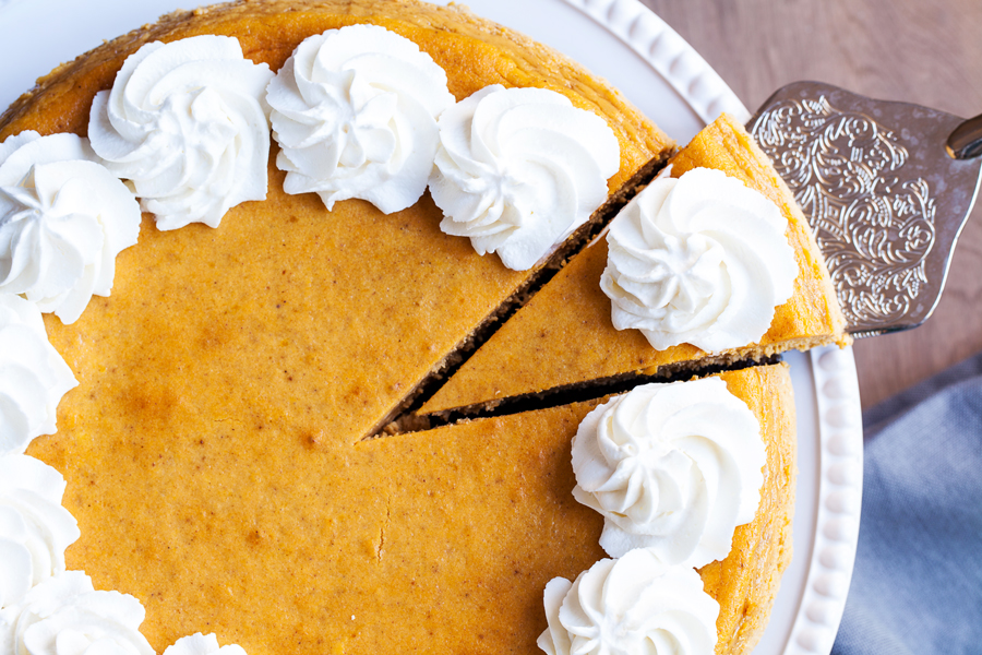 A gingersnap cookie crust, a layer of chocolate cake, and creamy pumpkin cheesecake make this the Ultimate Pumpkin Cheesecake.