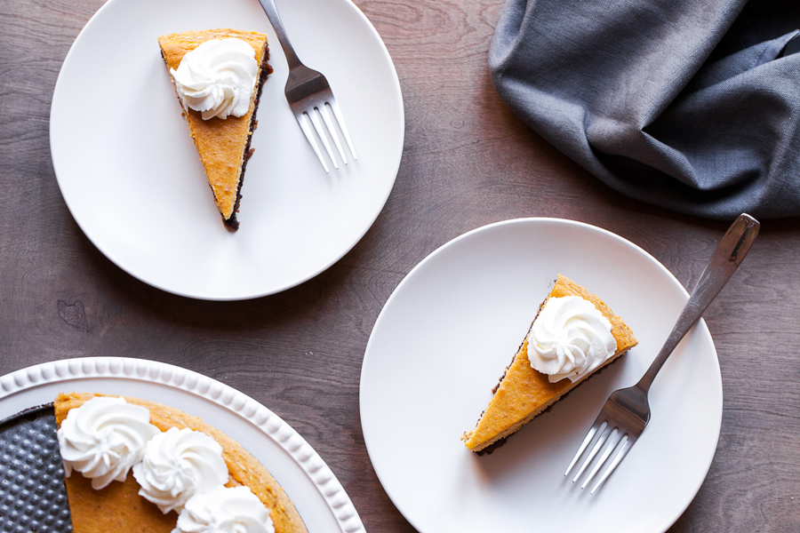 A gingersnap cookie crust, a layer of chocolate cake, and creamy pumpkin cheesecake make this the Ultimate Pumpkin Cheesecake.