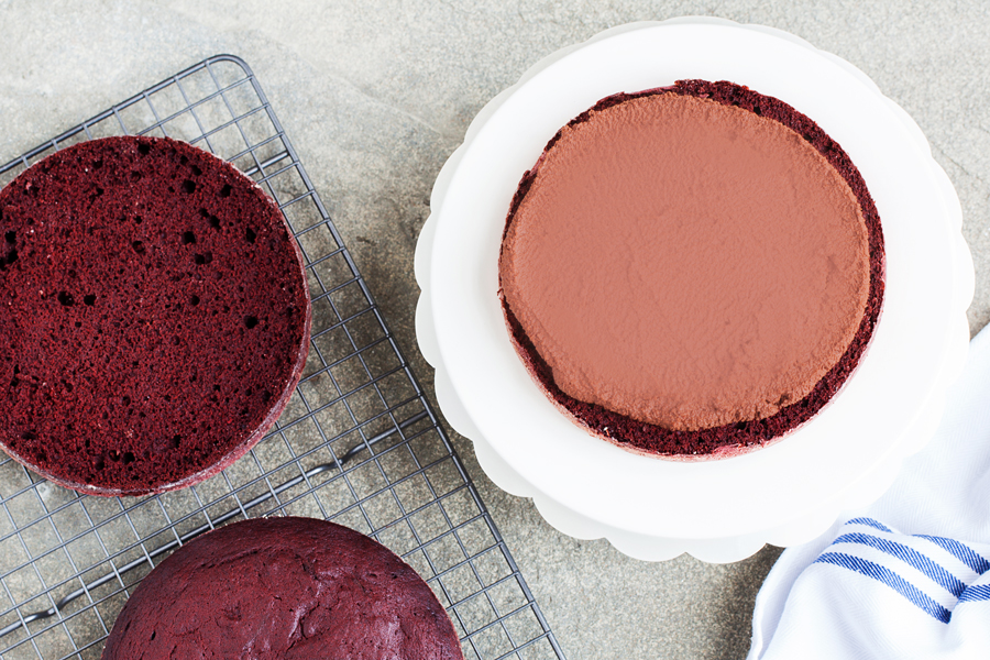 A to-die-for combination, this Red Velvet Espresso Cake has three delicious layers of red velvet cake, filled with fluffy espresso cream in between, and topped with sweet and tangy cream cheese frosting!