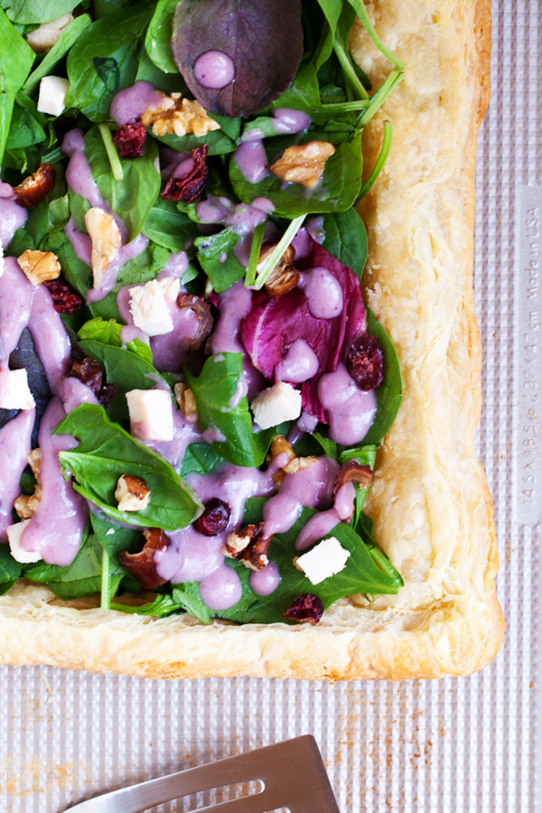 Puff pastry topped with fresh greens and a drizzle of blueberry lemon dressing make this Chicken Waldorf Salad Tart a delicious appetizer or light lunch option for all your holiday parties.