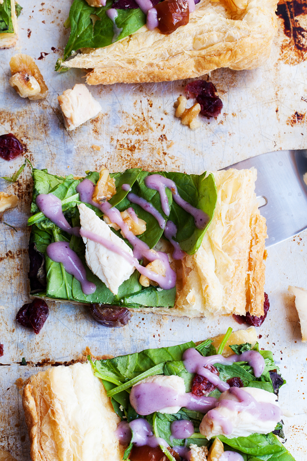 Puff pastry topped with fresh greens and a drizzle of blueberry lemon dressing make this Chicken Waldorf Salad Tart a delicious appetizer or light lunch option for all your holiday parties.