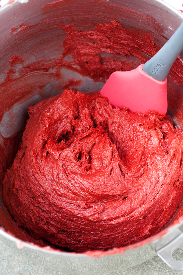 Chocolatey and buttery, these Lofthouse Style Red Velvet Wreath Cookies with cream cheese frosting will disappear at your next holiday party or cookie swap!