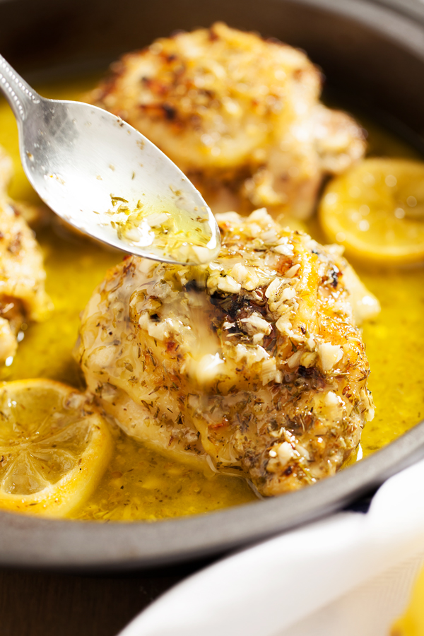 Sauce being poured on Ina Garten's Lemon Chicken 