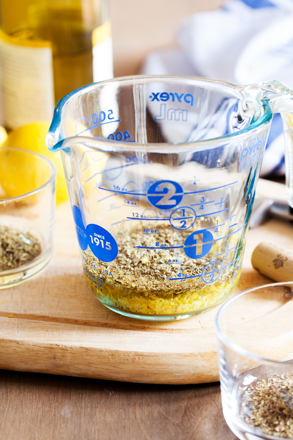 Preparation step for Ina Garten's Lemon Chicken - herbs, wine, and lemon juice in measuring cup