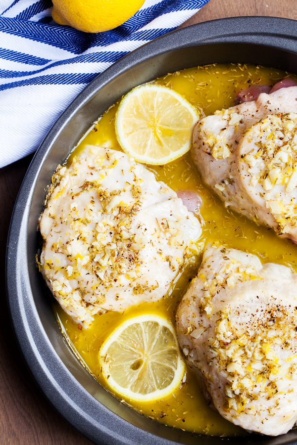 Preparation step for Ina Garten's Lemon Chicken - chicken thighs marinating in pan