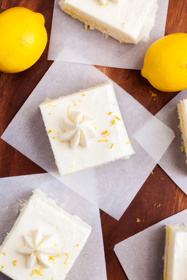 Two layers of soft white cake, lemon curd filling, and cream cheese frosting make this Lemon Snack Cake the perfect “light” and bright dessert.