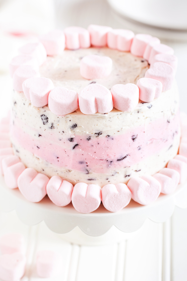 The perfect treat to end your Valentine’s Day dinner, this Valentine’s Day Oreo Cake has two layers of moist and fluffy white cake and is filled and covered with a vanilla and Oreo cookie crumb buttercream.