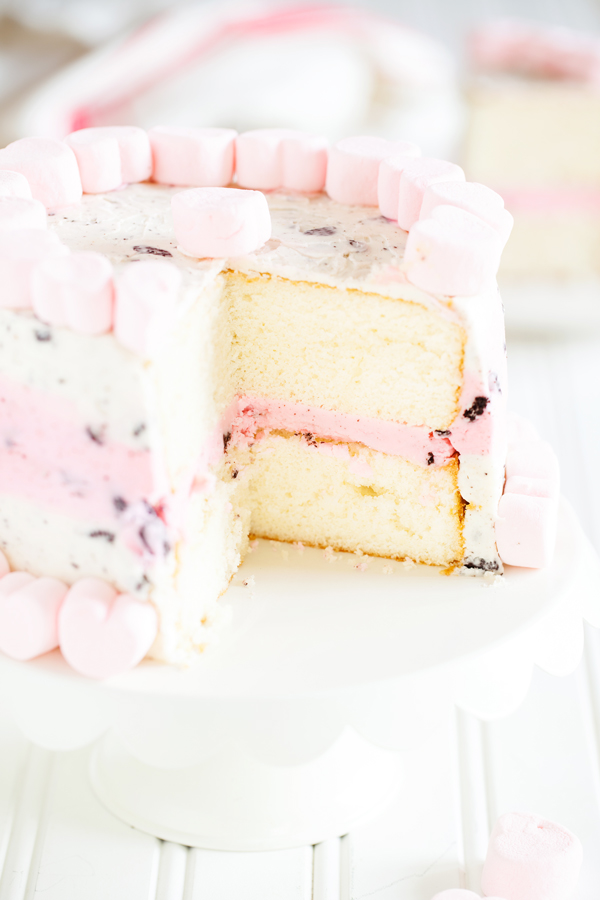 The perfect treat to end your Valentine’s Day dinner, this Valentine’s Day Oreo Cake has two layers of moist and fluffy white cake and is filled and covered with a vanilla and Oreo cookie crumb buttercream.