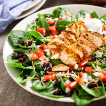 Chicken Spinach Taco Salad - Juicy and perfectly seasoned chicken served on a bed of fresh spinach leaves and topped with black beans and homemade pico de gallo.