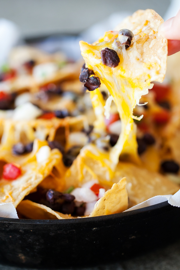 These Better than Restaurants Skillet Nachos gives you cheese in every bite and is topped with plenty of toppings.