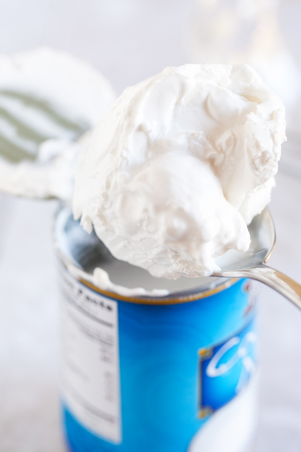 Moist and fluffy coconut cake is studded with shredded coconut, filled and covered with a luscious coconut frosting made from coconut milk, and adorned with BOTH toasted coconut and sweetened coconut.