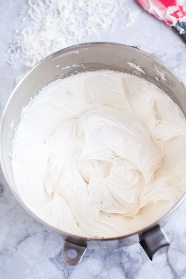 Moist and fluffy coconut cake is studded with shredded coconut, filled and covered with a luscious coconut frosting made from coconut milk, and adorned with BOTH toasted coconut and sweetened coconut.