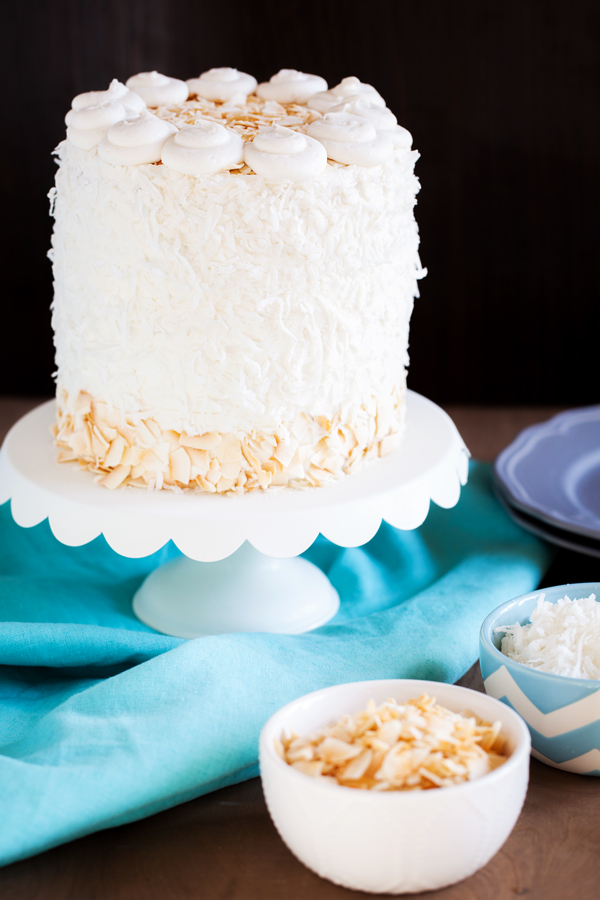 Moist and fluffy coconut cake is studded with shredded coconut, filled and covered with a luscious coconut frosting made from coconut milk, and adorned with BOTH toasted coconut and sweetened coconut.