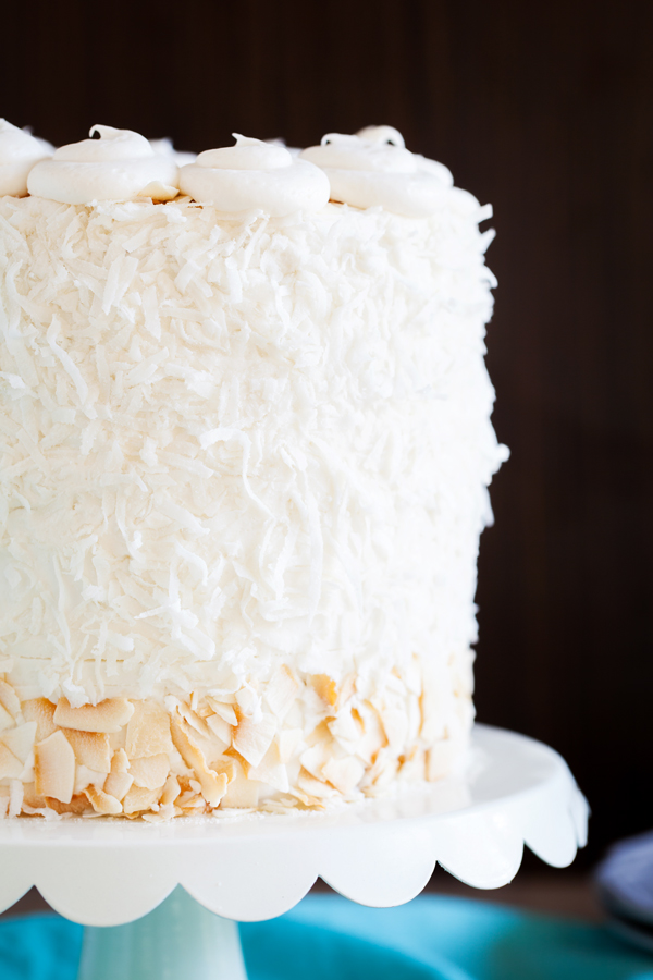 Moist and fluffy coconut cake is studded with shredded coconut, filled and covered with a luscious coconut frosting made from coconut milk, and adorned with BOTH toasted coconut and sweetened coconut.